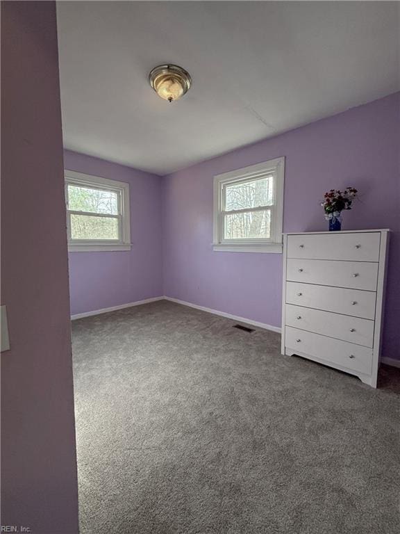 spare room with carpet flooring and a healthy amount of sunlight