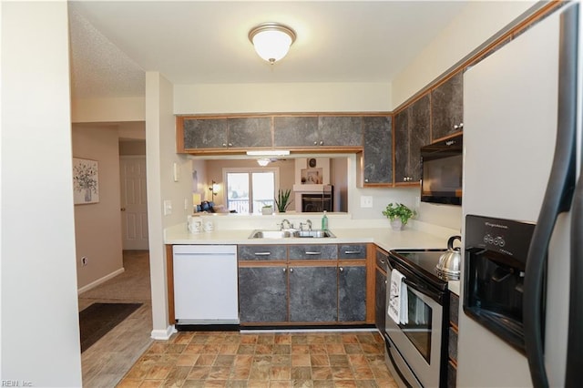 kitchen featuring dark brown cabinets, white appliances, and sink