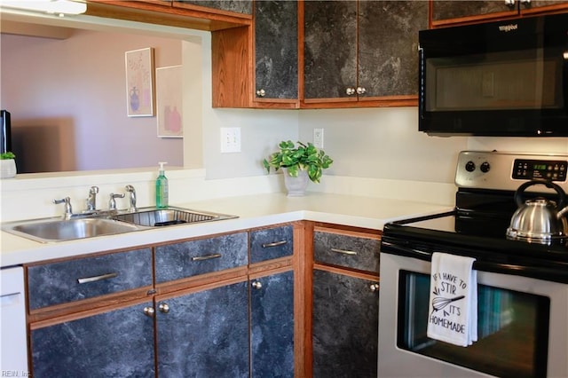 kitchen featuring dishwashing machine, sink, and stainless steel range with electric cooktop