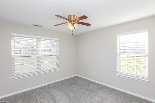 unfurnished room featuring ceiling fan and carpet floors