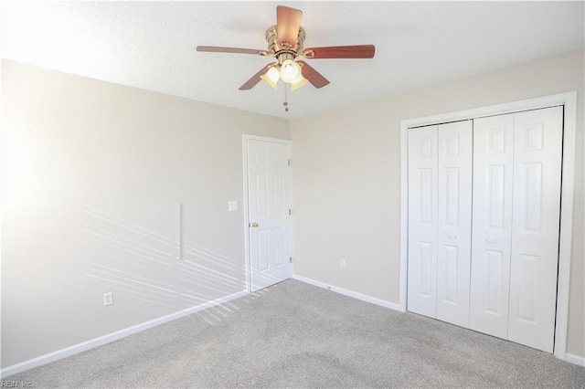 unfurnished bedroom featuring ceiling fan, light carpet, and a closet