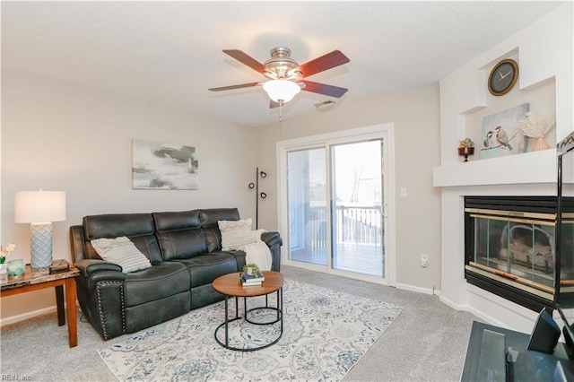 carpeted living room with ceiling fan