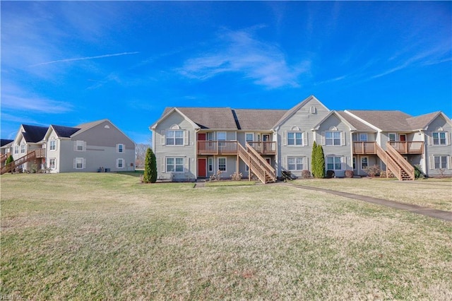 townhome / multi-family property with a wooden deck and a front lawn