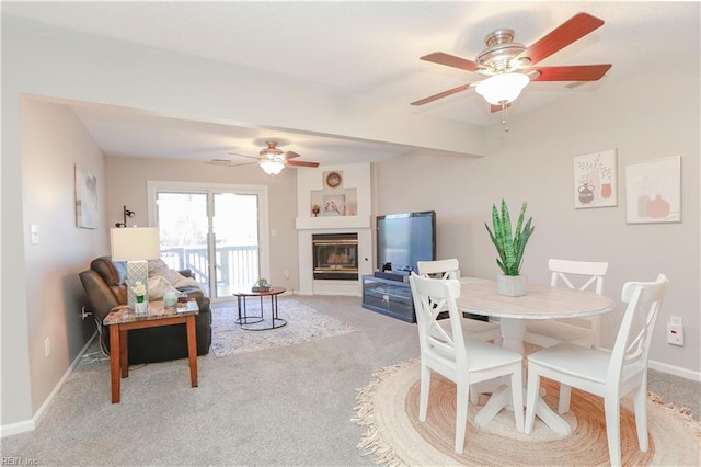 dining space featuring light colored carpet and ceiling fan