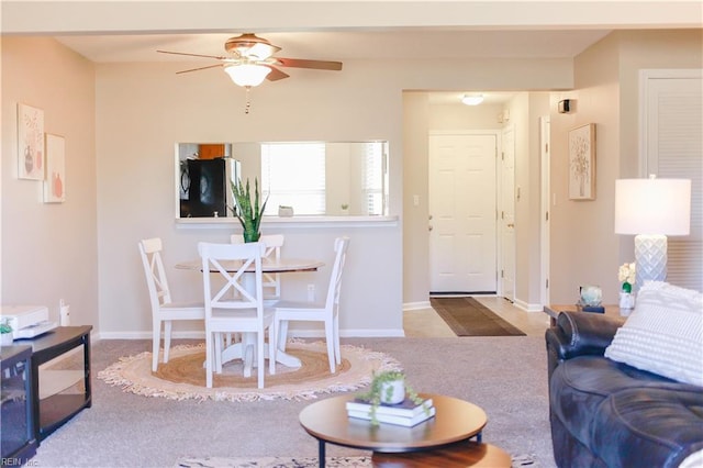 living room with ceiling fan and light carpet