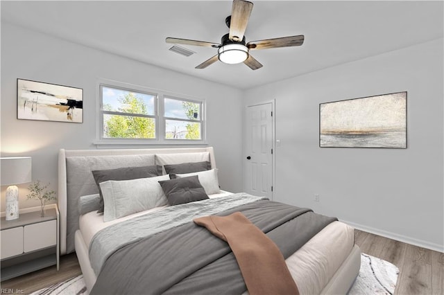 bedroom featuring hardwood / wood-style floors and ceiling fan