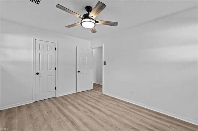 unfurnished bedroom with ceiling fan and light wood-type flooring