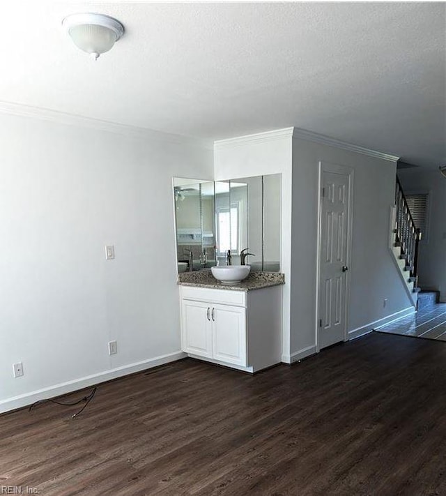 interior space featuring hardwood / wood-style floors, vanity, and crown molding