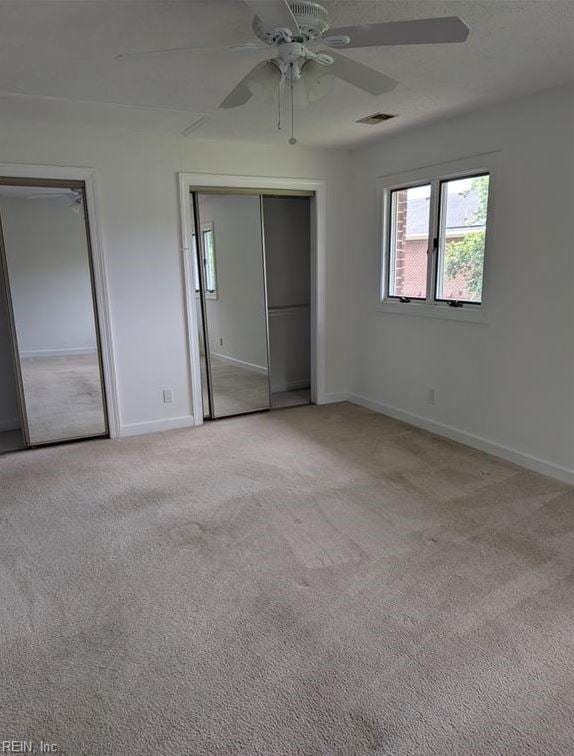 unfurnished bedroom with ceiling fan and light colored carpet