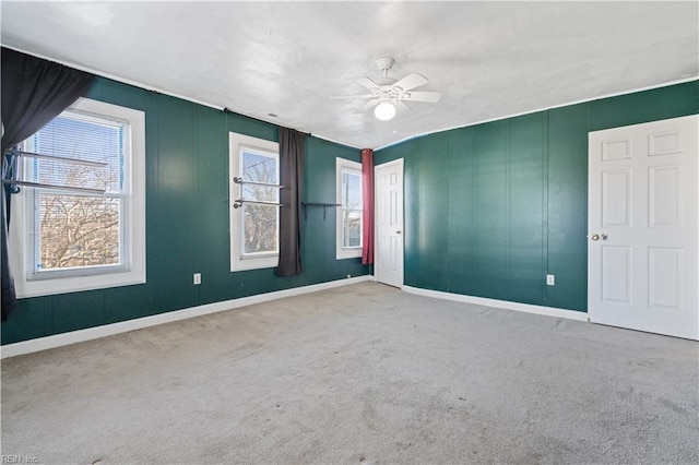 unfurnished room featuring ceiling fan and carpet floors