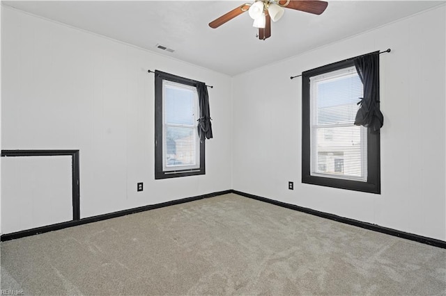 unfurnished room with ceiling fan and light carpet