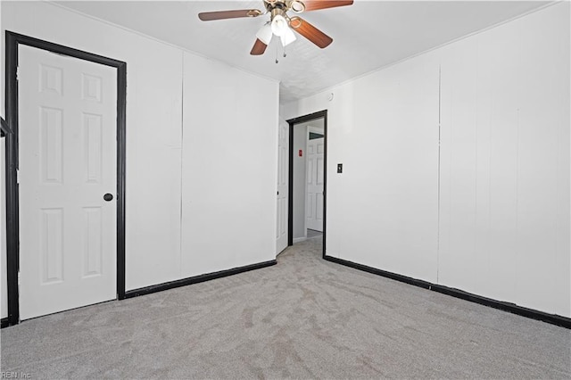 unfurnished room with ceiling fan and light carpet