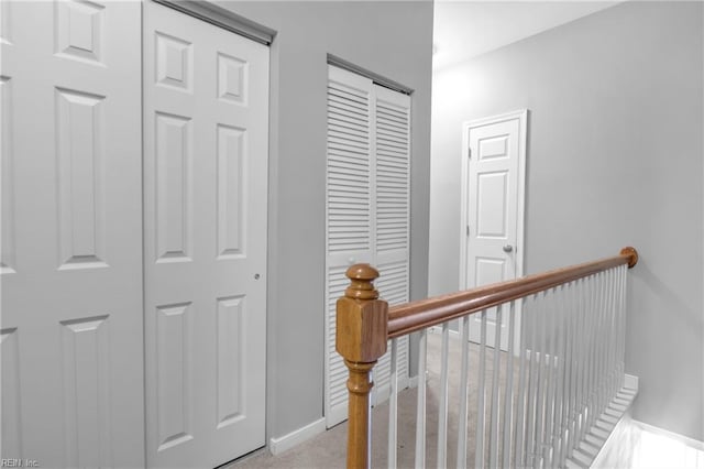 hallway with light colored carpet