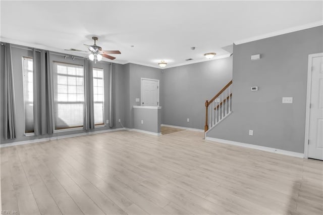 unfurnished living room with light hardwood / wood-style floors, ceiling fan, and ornamental molding