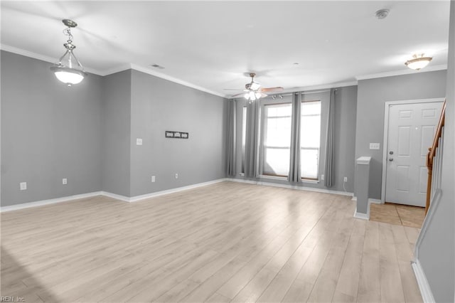 spare room featuring light hardwood / wood-style flooring, ceiling fan, and crown molding