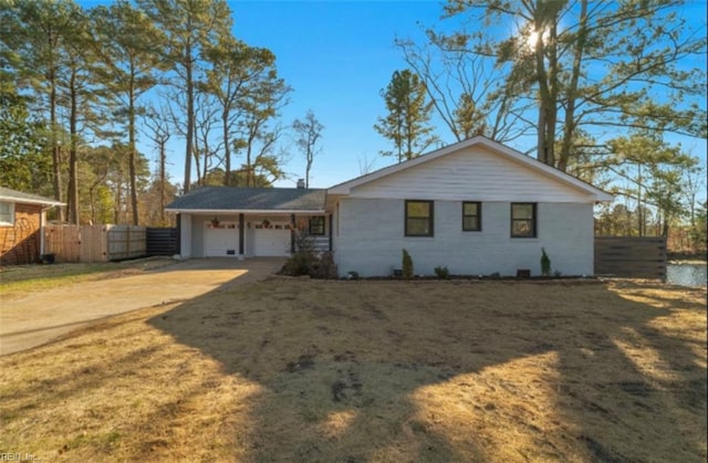 ranch-style house with a front yard and a garage