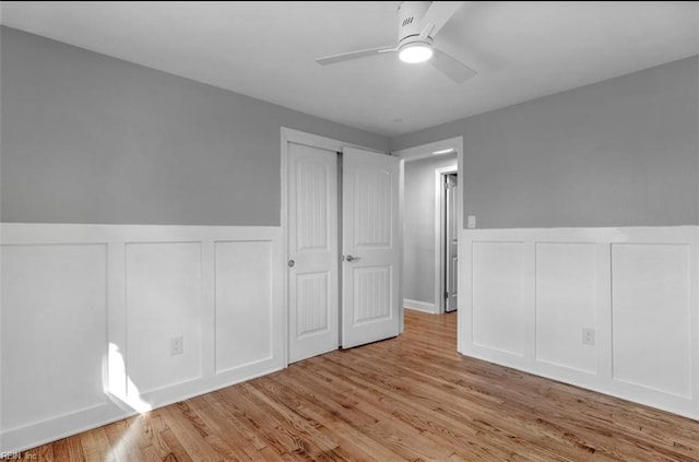 unfurnished bedroom with ceiling fan and light hardwood / wood-style floors