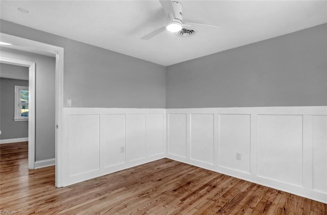 unfurnished room with light wood-type flooring and ceiling fan