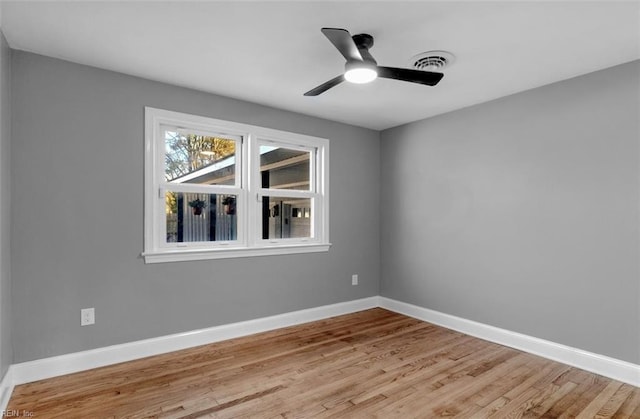 spare room featuring light hardwood / wood-style floors and ceiling fan