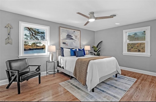 bedroom with ceiling fan and light hardwood / wood-style flooring