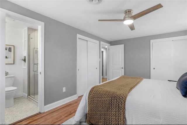 bedroom featuring hardwood / wood-style flooring, ensuite bath, and ceiling fan