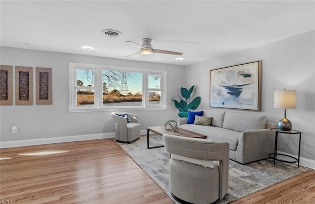 living room featuring light hardwood / wood-style floors and ceiling fan