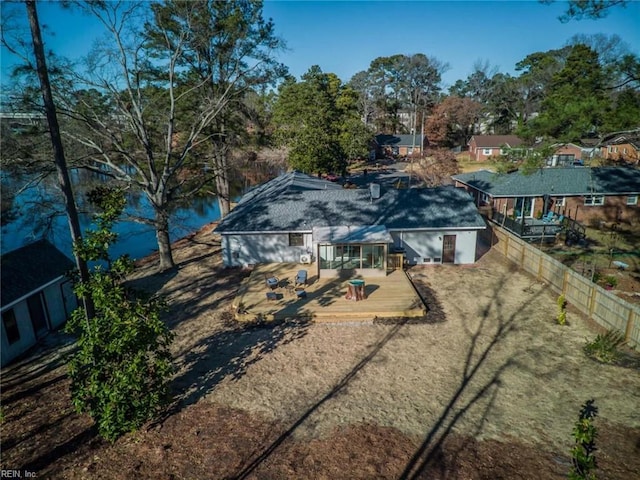 rear view of house with a deck with water view