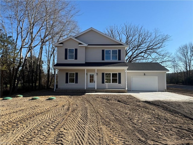 view of front property featuring covered porch and a garage