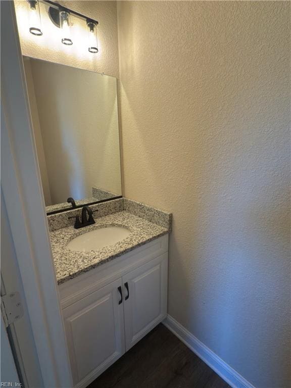 bathroom featuring hardwood / wood-style floors and vanity