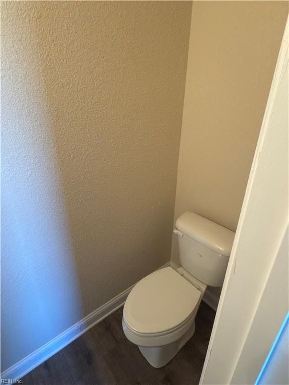 bathroom featuring hardwood / wood-style floors and toilet