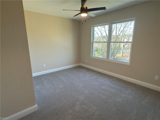 empty room featuring ceiling fan and carpet floors