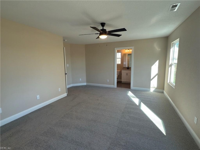 carpeted spare room with ceiling fan