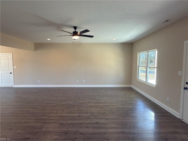 unfurnished living room with a textured ceiling, ceiling fan, and dark wood-type flooring