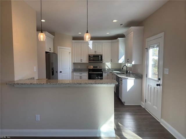 kitchen with kitchen peninsula, white cabinetry, hanging light fixtures, and appliances with stainless steel finishes