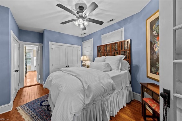 bedroom with hardwood / wood-style floors, a closet, and ceiling fan