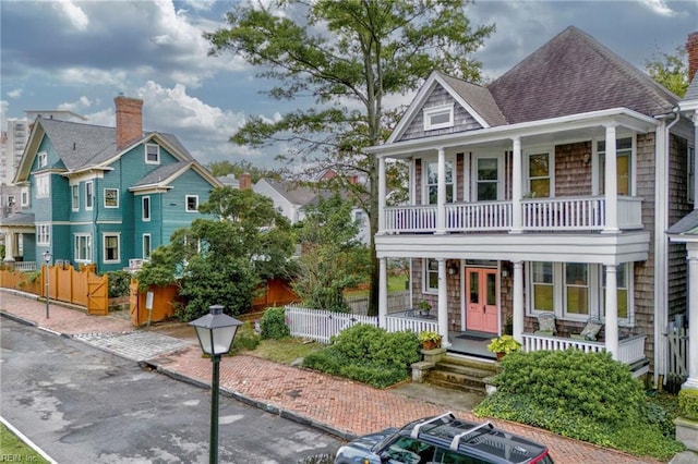 view of front facade featuring covered porch and a balcony