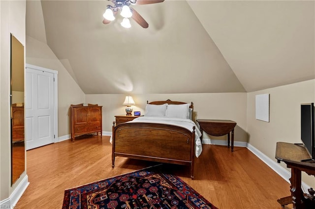 bedroom with ceiling fan, lofted ceiling, and light hardwood / wood-style flooring