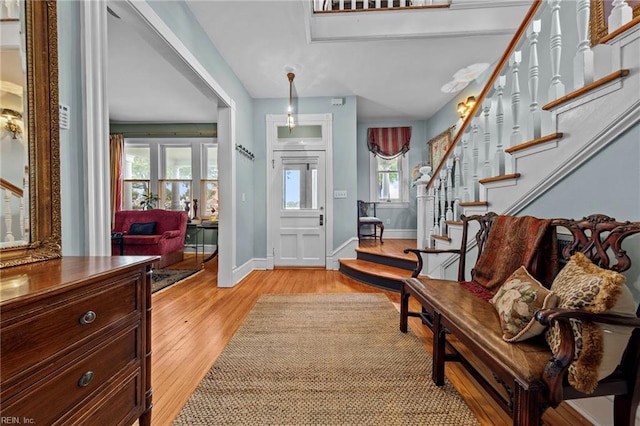 foyer with light hardwood / wood-style floors and a healthy amount of sunlight