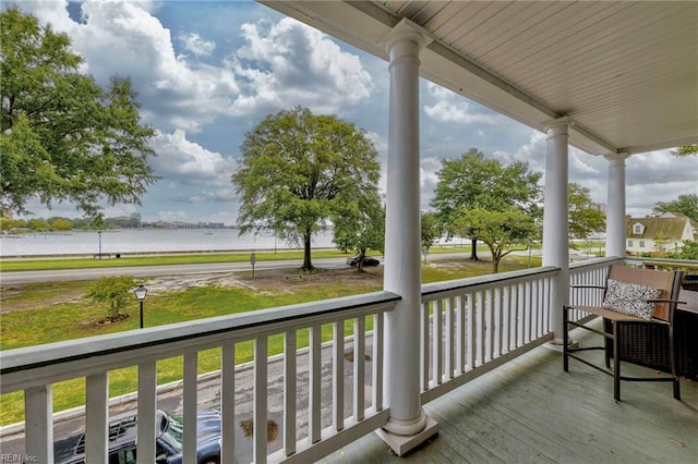 deck featuring a porch and a water view