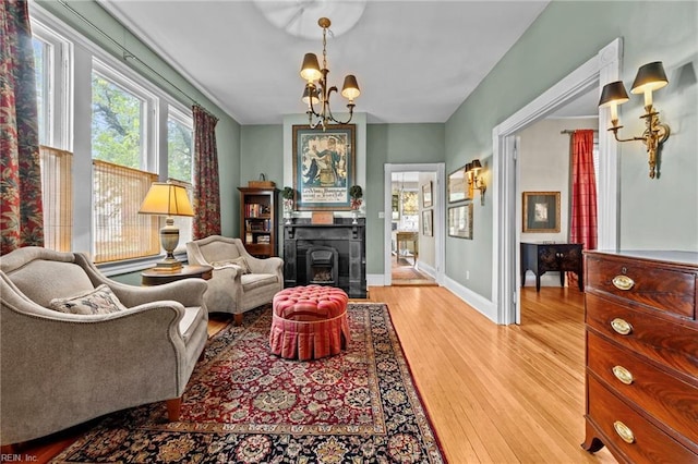 living area with a chandelier and light hardwood / wood-style floors