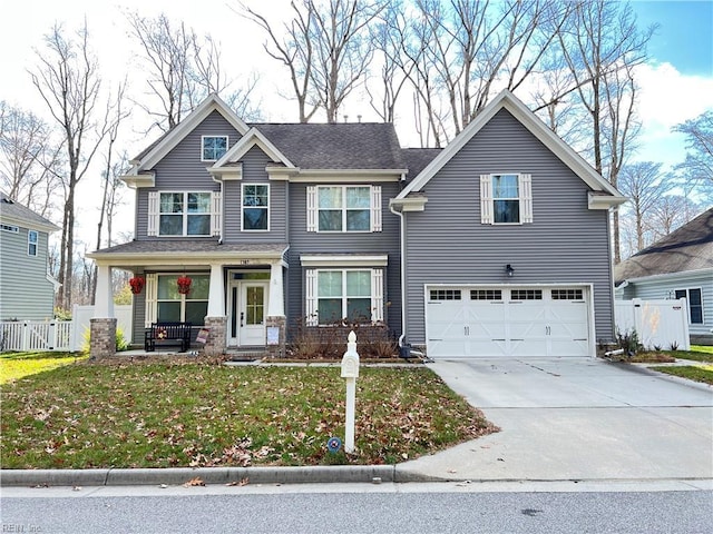 view of front of house with a porch, a garage, and a front yard