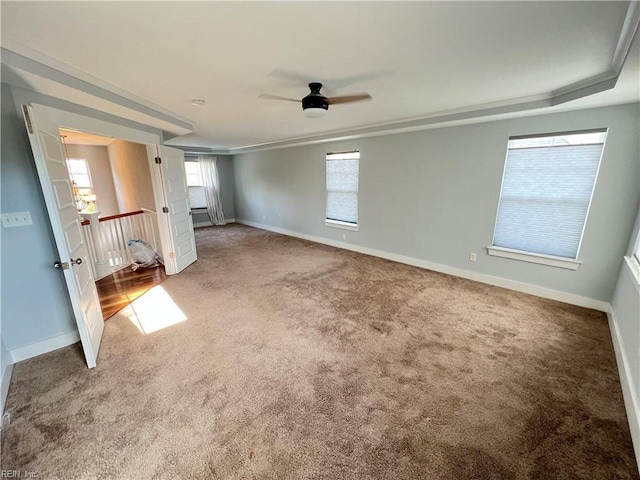 carpeted spare room featuring ceiling fan and ornamental molding