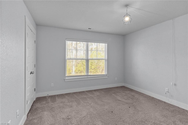 unfurnished room featuring light colored carpet