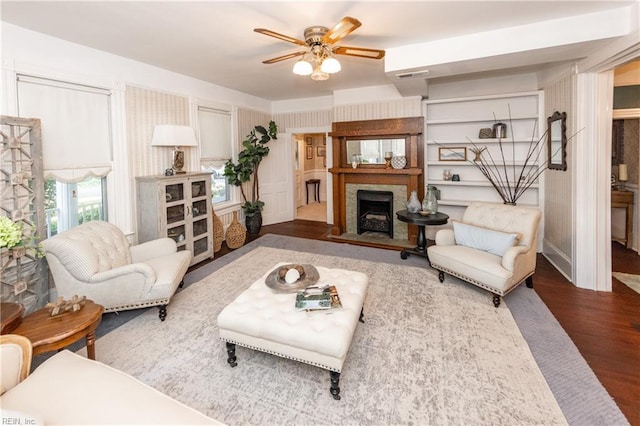 living room featuring ceiling fan and dark hardwood / wood-style floors