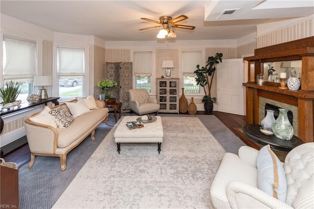 living room featuring ceiling fan and dark wood-type flooring