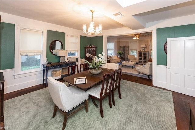 dining room featuring ceiling fan with notable chandelier, dark hardwood / wood-style floors, and a wealth of natural light