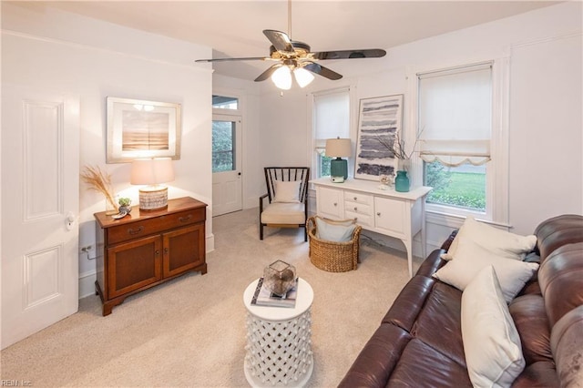 living room with light carpet and ceiling fan