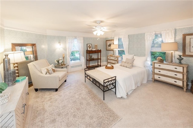 bedroom featuring light colored carpet and ceiling fan