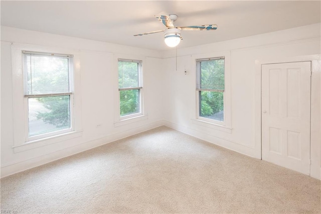 carpeted empty room with ceiling fan