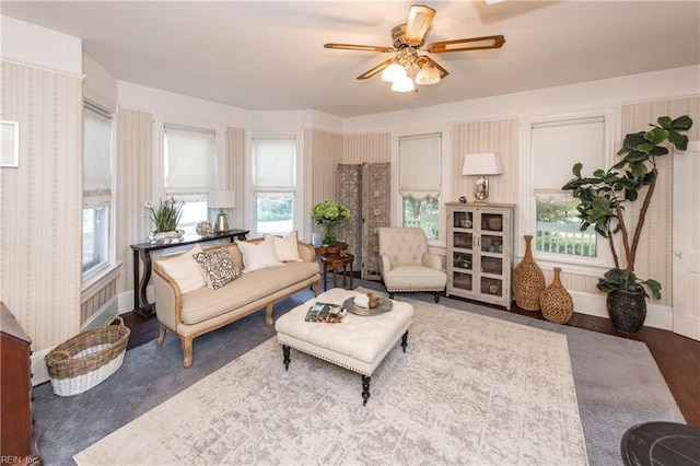 living room featuring hardwood / wood-style floors and ceiling fan